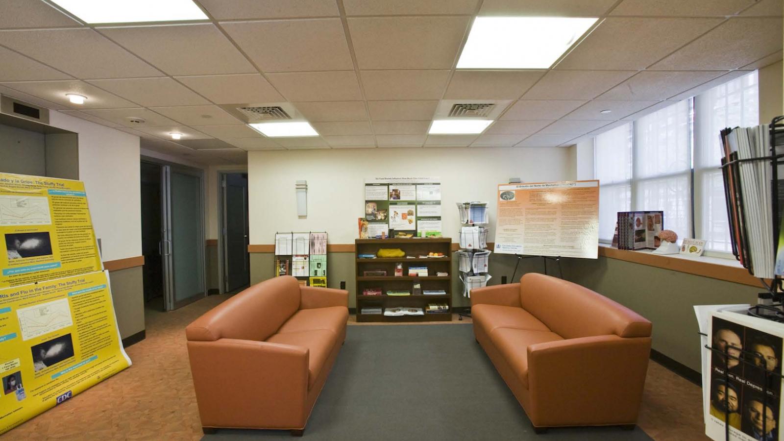 Two orange sofas in a room.