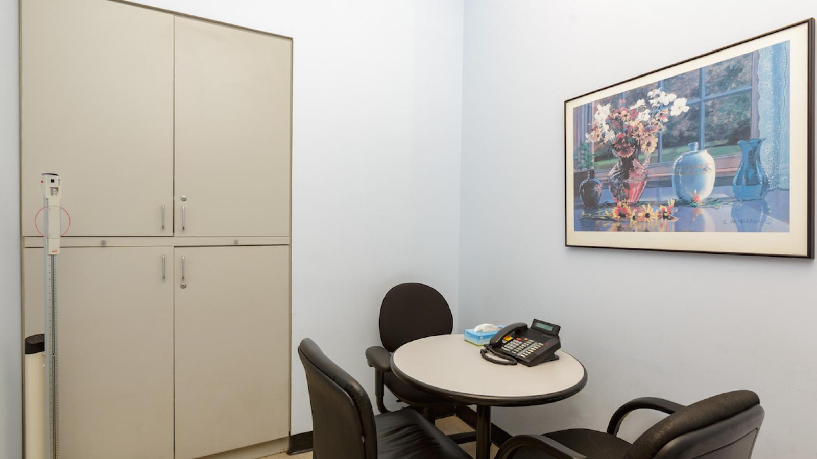 Empty room with table and 3 chairs.